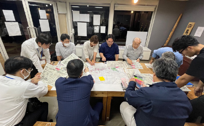 テーブルを囲み話し合う様子写真